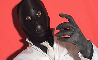 Man wearing a black hockey mask with a necktie