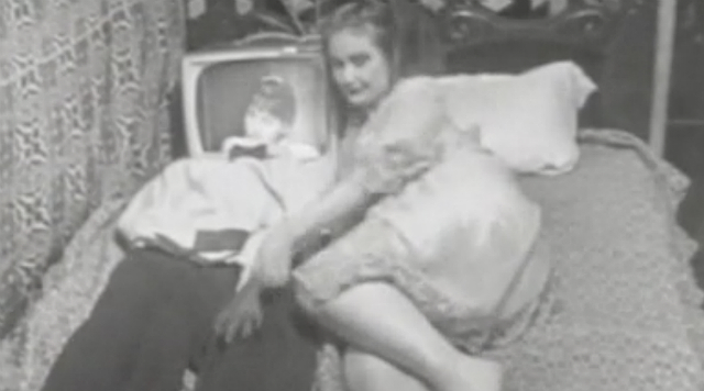 Breathdeath Woman lying in bed next to a man with a TV for a head