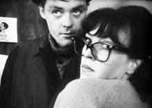 Film still from Chafed Elbows featuring a woman wearing glasses