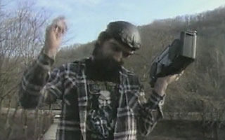Bearded man dancing on a bridge while listening to a boombox
