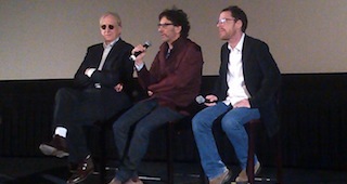 T-Bone Burnett, Joel Coen and Ethan Coen sitting on movie theater stage
