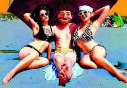 Man and two women in bikinis relax on the beach