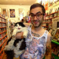 Brian Chankin Man in video store holding cat