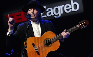 Musician Nenad Bach performing with an acoustic guitar