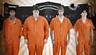Five teenagers wearing orange prison jumpsuits