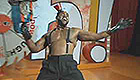 Shirtless African American man on game show stage