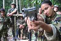 Female solider pointing a gun at the camera
