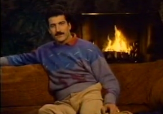 Baseball player Keith Hernandez sitting in front of a fire