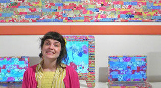 Jodie Mack Jodie Mack standing in front of her colorful art installation