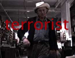 Filmmaker Jonas Mekas strutting with the word "terrorist" superimposed over him