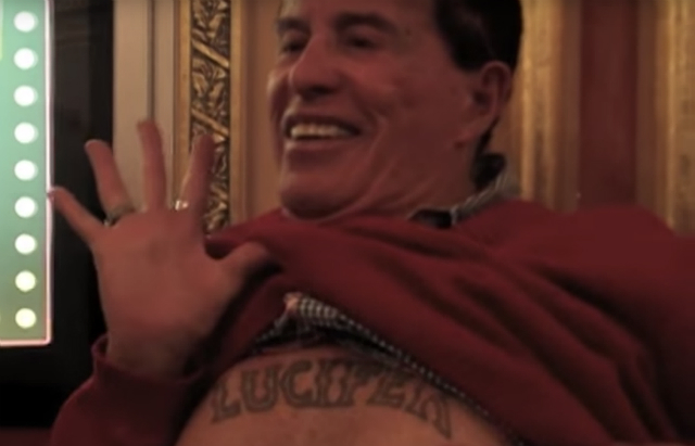Kenneth Anger Kenneth Anger flashes his Lucifer tattoo under his sweater