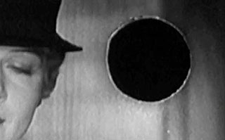 Old movie frame with a woman wearing a hat and a projectionist burn