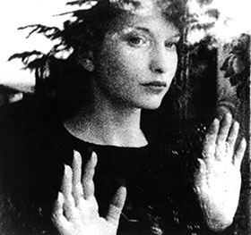 Maya Deren looking out a window in Meshes of the Afternoon