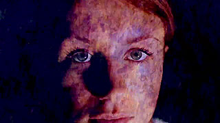 Close-up of a woman with an abstract image projected on her face
