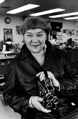 Portrait of filmmaker and painter Marie Menken holding a Bolex movie camera