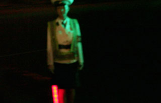 Korean airline worker stands with her light wand