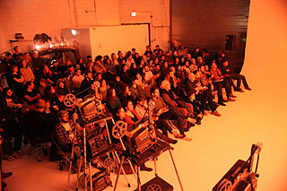 Audience members watching an expanded cinema performance in Brooklyn