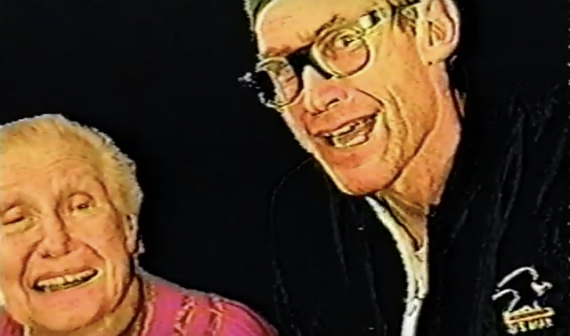 A man wearing glasses poses with his elderly mother