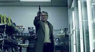 Retired police detective pointing a gun in a convenience store