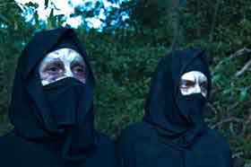 Scars of Youth Two people covering their scarred faces with cloth