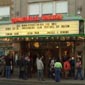 Exterior marquee of the Somerville Theatre with crowd lined up beneath it