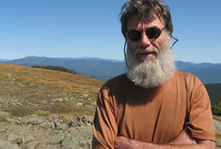 Portrait of filmmaker Skip Battaglia standing on a mountain