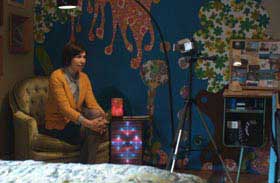 Carrie Brownstein talks directly to a video camera