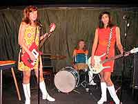 Three girl rock combo band perform on stage