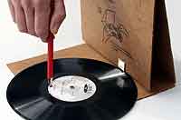 Tailenders Person playing a vinyl record with a pen