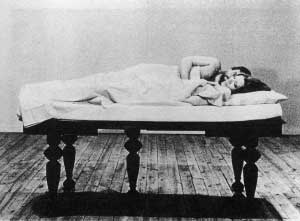 Film still from Film About a Woman Who by Yvonne Rainer featuring a couple in bed