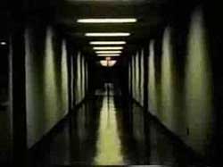 Film still from Serene Velocity by Ernie Gehr featuring a shadowy hallway
