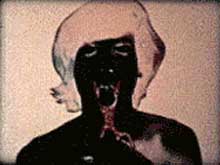 Film still of T,O,U,C,H,I,N,G by Paul Sharits featuring a man getting his tongue cut