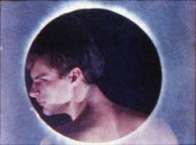 Film still of Twice a Man featuring a shirtless men framed by a glowing circle