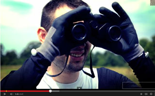 Superhero looks through binoculars