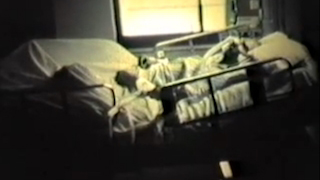 Dying man lying in a hospital bed