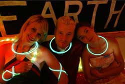 Three hipsters wearing glowsticks