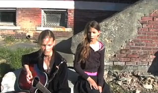 Two musical sisters sing and play guitar